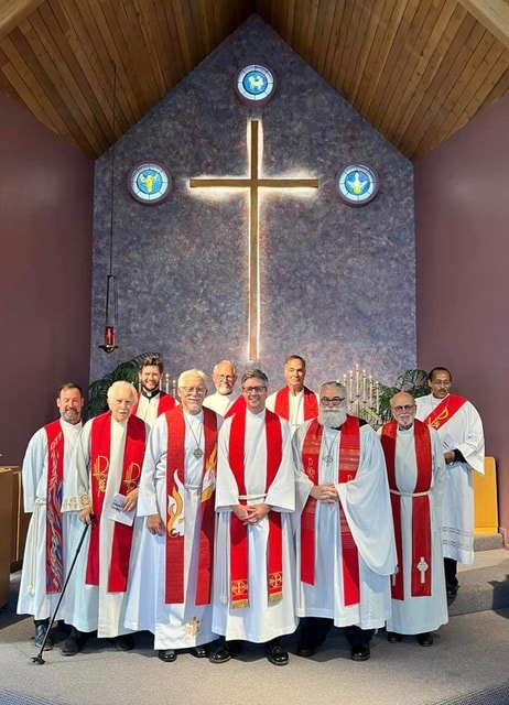 Clergy in red vestments at the altar